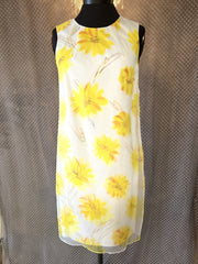 Marccain yellow floral dress featuring a vibrant design, perfect for summer occasions with a stylish and versatile look.