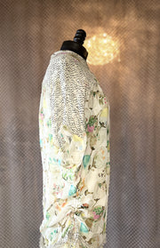 Side view of a Marccain silk blouse featuring delicate floral patterns and sheer detailing, perfect for a stylish wardrobe.