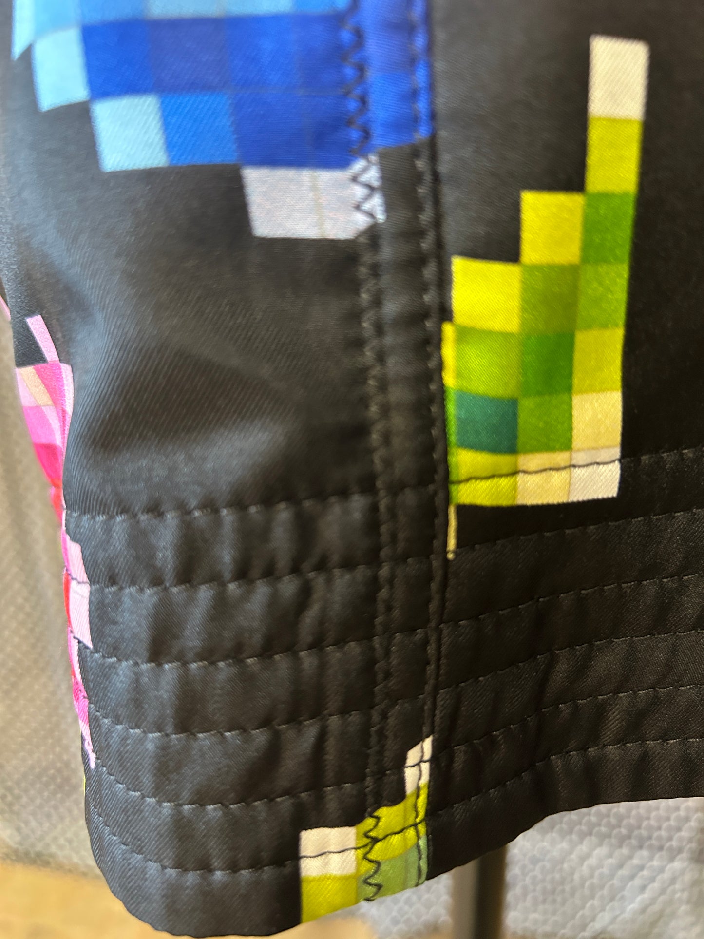 Close-up of Marccain Nonograms Pattern Skirt showcasing colorful pixelated design and black fabric, emphasizing playful style.