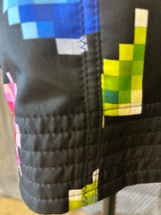 Close-up of Marccain Nonograms Pattern Skirt showcasing colorful pixelated design and black fabric, emphasizing playful style.