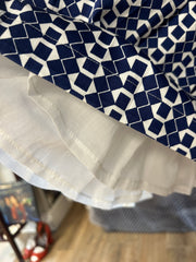 Close-up of Seventy Blue Pattern Petti Skirt showcasing vivid blue diamond pattern and layered hem detail.