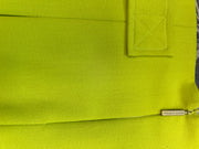Close-up of Versace fluorescent green skirt showcasing fabric texture and branding detail.