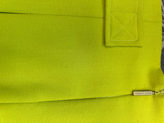 Close-up of Versace fluorescent green skirt showcasing fabric texture and branding detail.