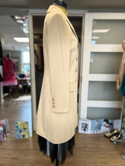 Side view of the elegant Laurel Creamy Wool Coat, showcasing its tailored design and luxurious fabric details.