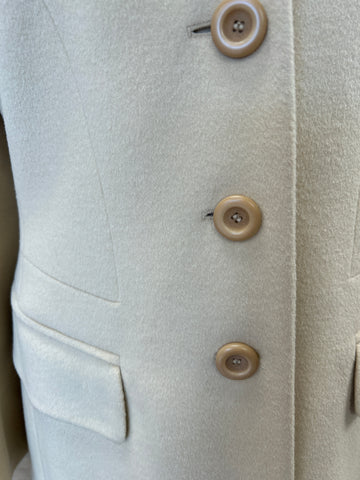 Close-up of the Laurel Creamy Wool Coat showing soft fabric, buttons, and pockets for an elegant outerwear look.