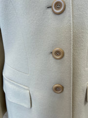 Close-up of the Laurel Creamy Wool Coat showing soft fabric, buttons, and pockets for an elegant outerwear look.