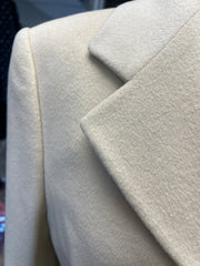 Close-up of Laurel Creamy Wool Coat, showcasing its soft wool texture and elegant lapel design.