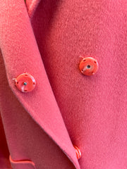 Close-up of Marccain coral red long coat detail featuring stylish buttons and soft fabric texture.