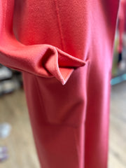 Close-up of Marccain coral red long coat showcasing the soft fabric and stylish sleeve design.