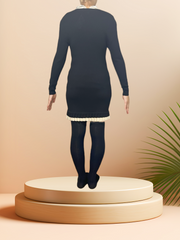 Back view of a Crisca black wool dress with a ruffled hem, set against a soft background.