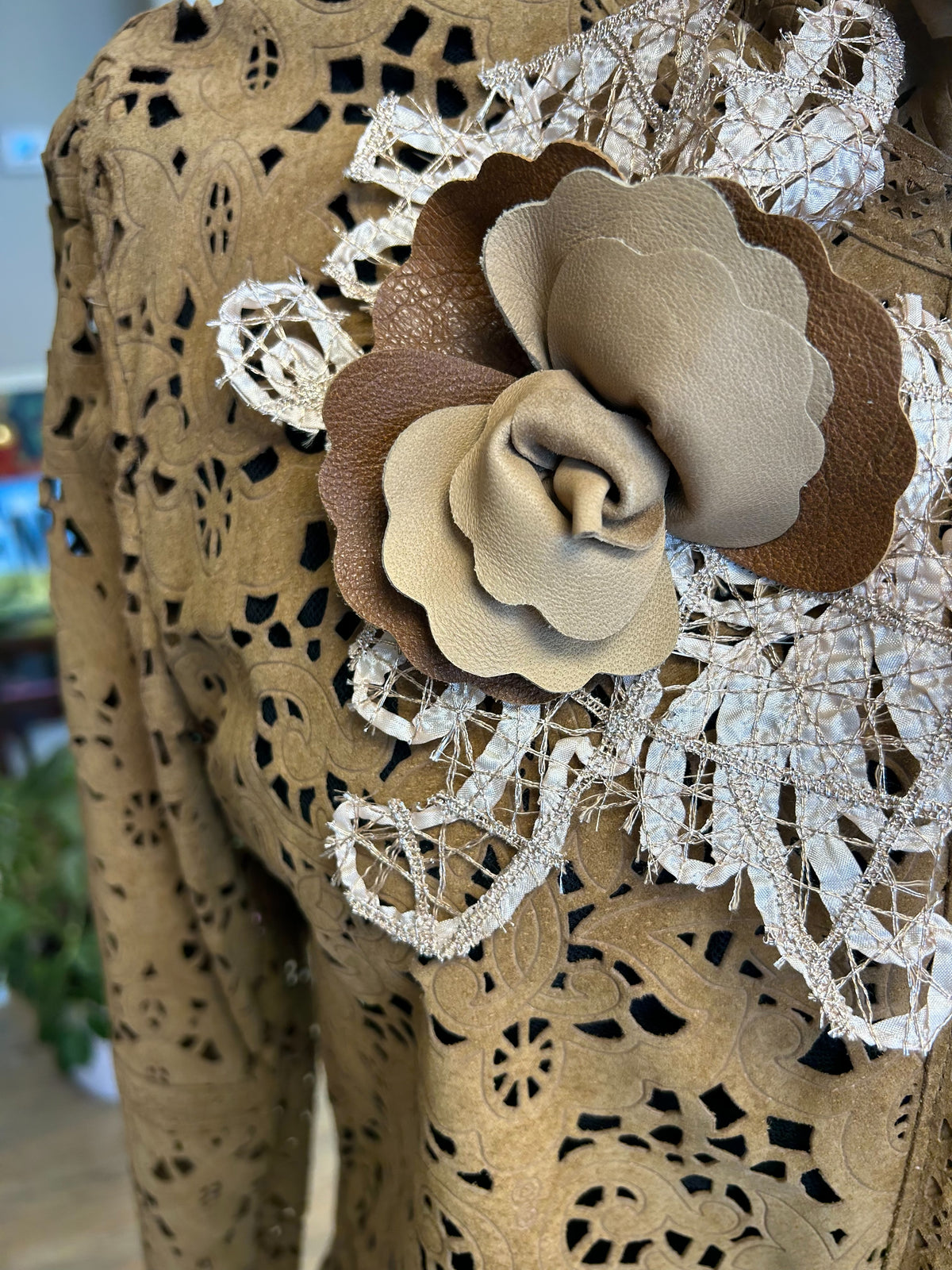 Save the Queen Hollow Carving Leather Coat close-up showing intricate design and floral accent, perfect for spring outfits.