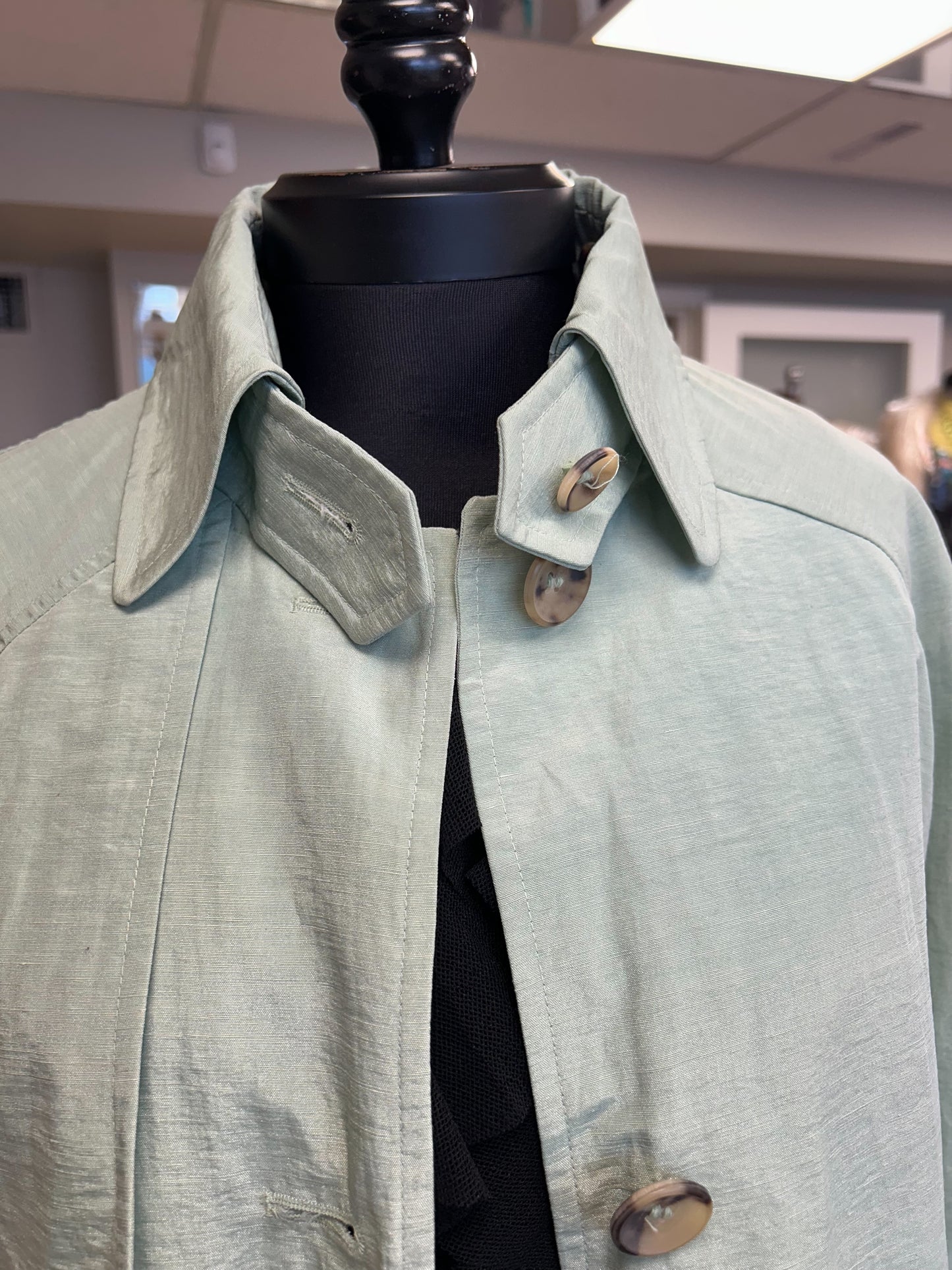 Nic Janik Green Linen Coat featuring light green fabric and stylish collar options, perfect for spring fashion.