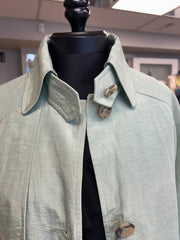 Nic Janik Green Linen Coat featuring light green fabric and stylish collar options, perfect for spring fashion.