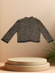 Marccain Green Spring Jacket displayed on a pedestal, showcasing its stylish design and textured fabric.