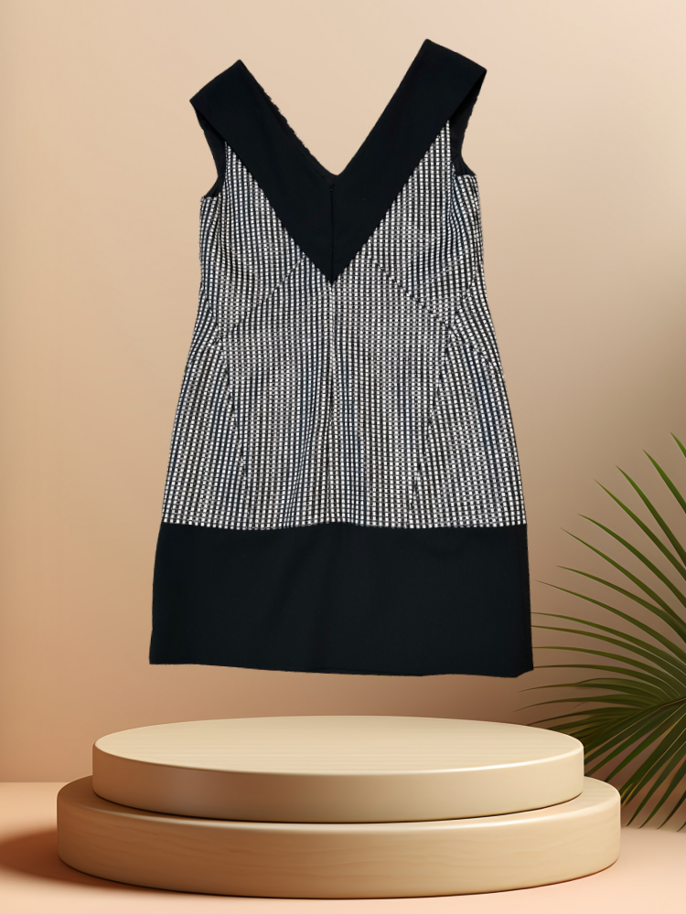Versace Black & White Checked Dress displayed elegantly on a pedestal, showcasing its stylish design and quality craftsmanship.