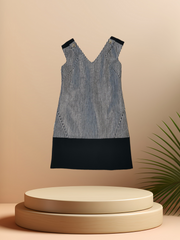Versace black and white checked dress displayed on a pedestal, showcasing its elegant design and craftsmanship.