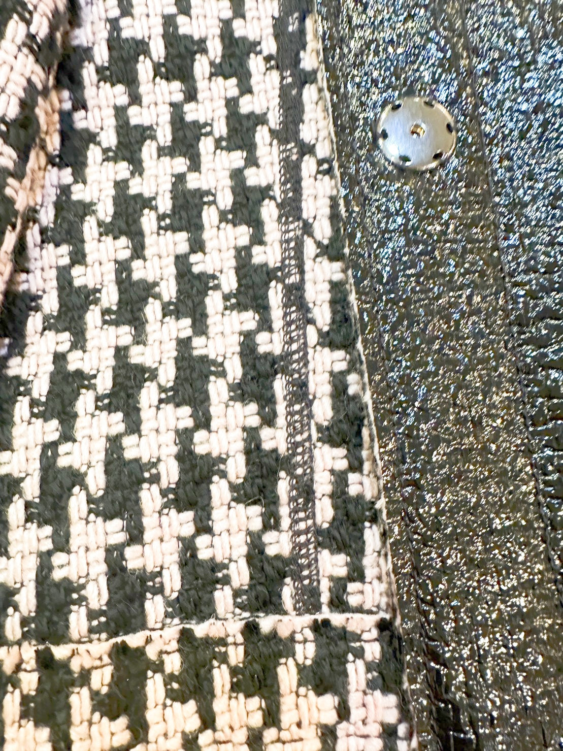 Close-up of Marccain Reversible Jacket showing elegant Houndstooth pattern and sleek black leather look.