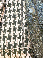 Close-up of Marccain Reversible Jacket showing elegant Houndstooth pattern and sleek black leather look.