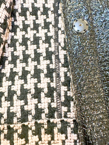 Close-up of Marccain Reversible Jacket showing elegant Houndstooth pattern and sleek black leather look.