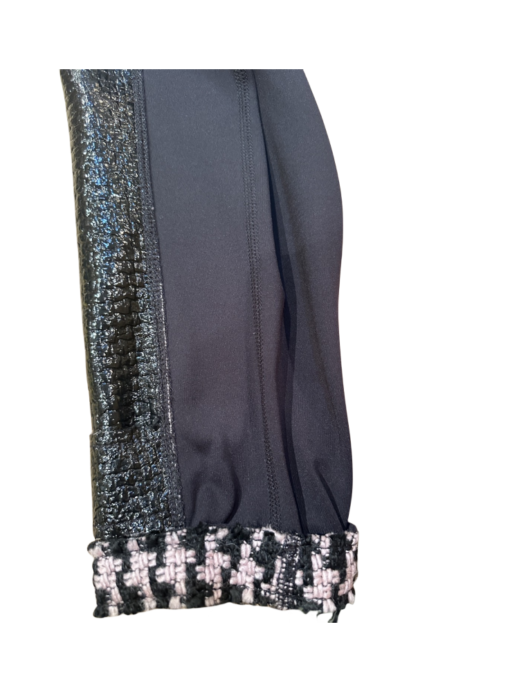 Close-up of the sleeve of the Marccain Reversible Jacket showcasing black leather and Houndstooth detail.