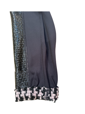 Close-up of the sleeve of the Marccain Reversible Jacket showcasing black leather and Houndstooth detail.