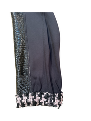 Close-up of the sleeve of the Marccain Reversible Jacket showcasing black leather and Houndstooth detail.