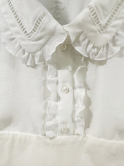 Close-up of Marccain white blouse with flounce collar and buttons, showcasing its elegant design.