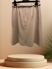 Seventy A-Line Skirt in luxurious wool with waist belt, displayed on a pedestal against a soft background.