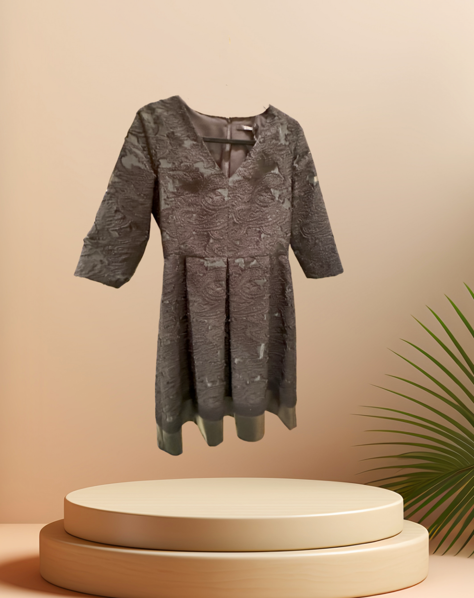 Elegant Seventy Black Lace Dress showcasing intricate lace detailing and modern silhouette against a soft background.