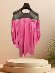 Vibrant pink off-the-shoulder dress with black tulle neckline displayed on a pedestal, perfect for stylish occasions.