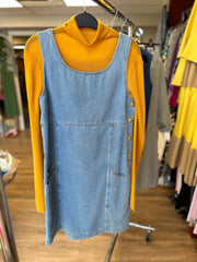 Escada Denim Dress featuring a sleeveless design with A-line shape, paired with a mustard turtleneck, showcasing casual style.