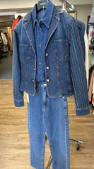 Escada denim jacket with stylish tailored collar, intricate stitches, displayed with matching denim pants on a hanger.