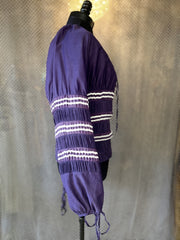 Side view of Jean's Paul Gaultier purple blouse with puff sleeves and elegant striped detailing.