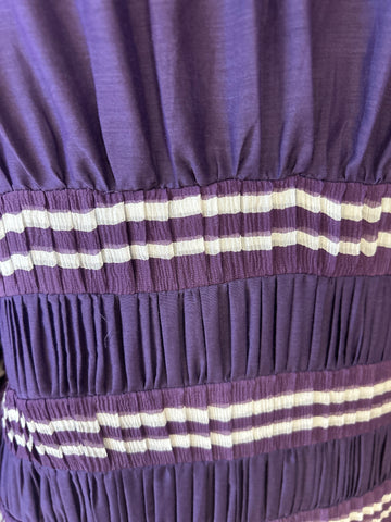 Close-up of Jean's Paul Gaultier purple blouse with pleated texture and striped details, made from cotton and silk blend.