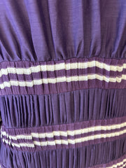Close-up of Jean's Paul Gaultier purple blouse with pleated texture and striped details, made from cotton and silk blend.