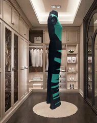 Madame Moje Green Dress displayed in a stylish modern wardrobe, featuring a form-fitting cut and zip zap stripes.