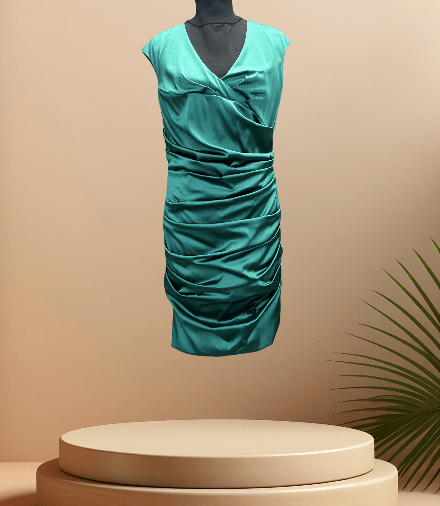 Marccain green satin dress with unique wrinkled design, perfect for special occasions, displayed on a pedestal.