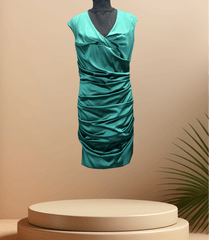 Marccain green satin dress with unique wrinkled design, perfect for special occasions, displayed on a pedestal.