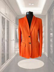 Marccain Red Jacket displayed on a mannequin in a stylish modern closet, showcasing its classic cut and elegant design.
