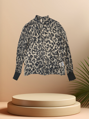 Marccain silk leopard print shirt showcased on a display with a modern aesthetic, highlighting its trendy design.