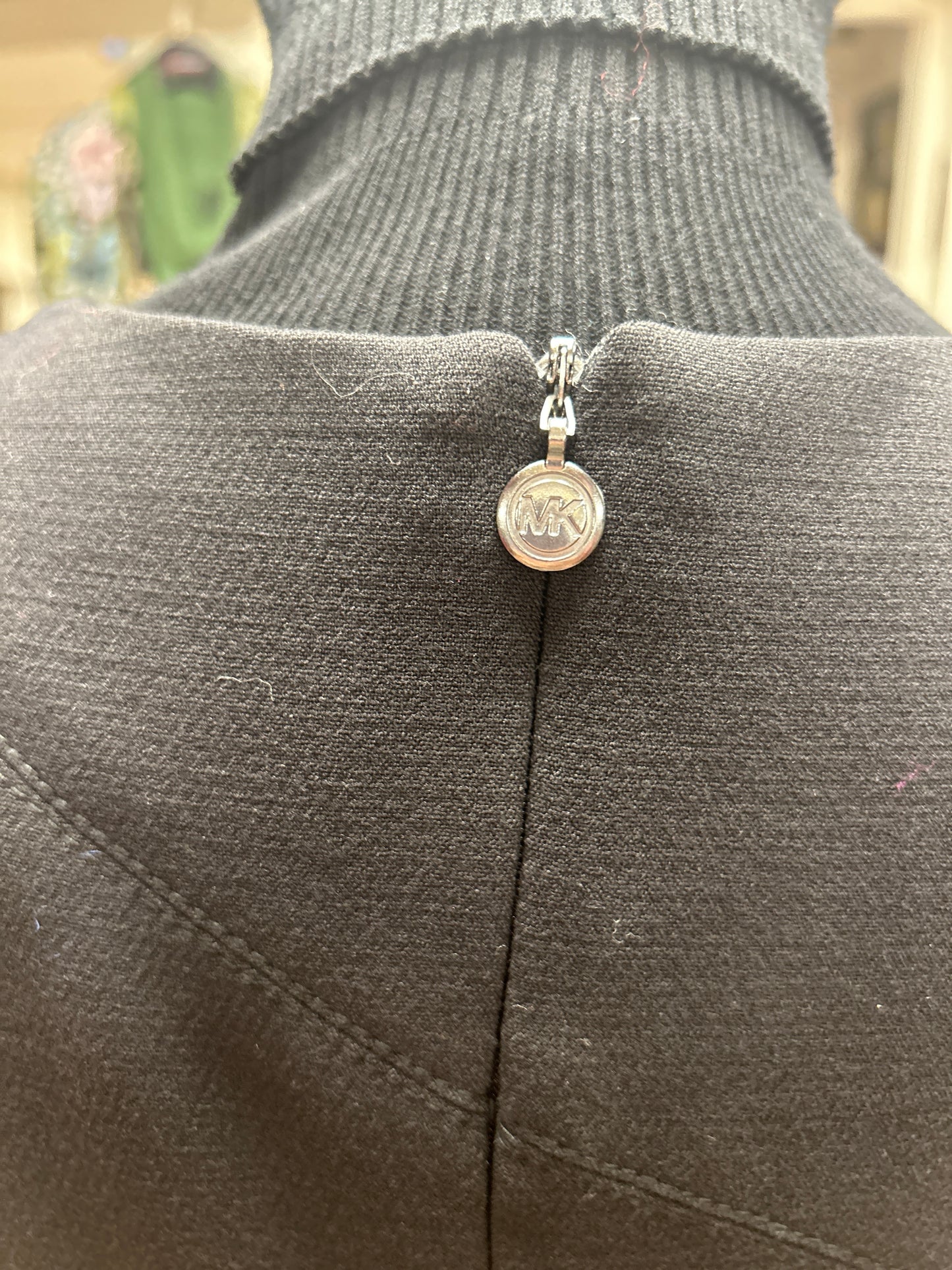 Back view of Michael Kors Rivet Dress showcasing the elegant zipper detail and iconic logo.