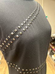 Close-up of the Michael Kors Rivet Dress showcasing rivet decoration on a classic black fabric.