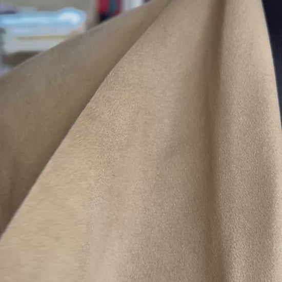 Close-up of Michael Kors suede leather coat showcasing soft texture and warm beige color.