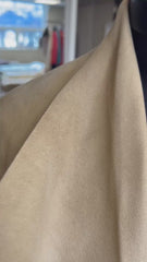 Close-up of Michael Kors suede leather coat showcasing soft texture and warm beige color.