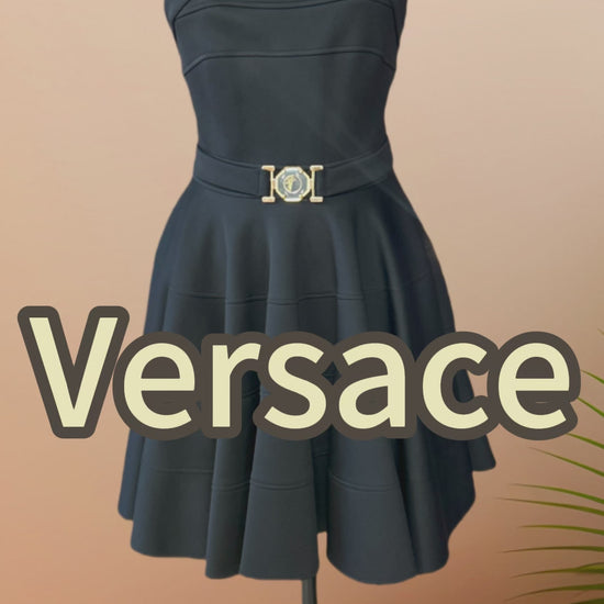 Versace black dress featuring a low cut back, strip sleeves, and circular skirt for a chic and feminine look.