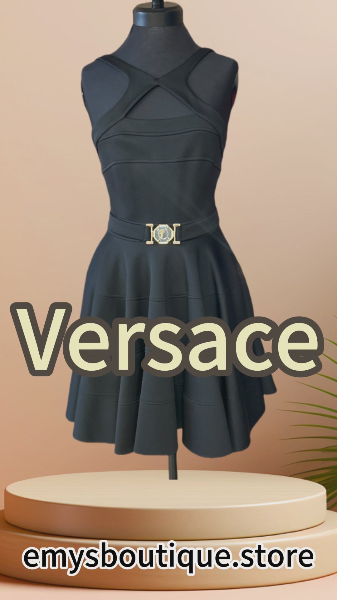 Versace black dress featuring a low cut back, strip sleeves, and circular skirt for a chic and feminine look.