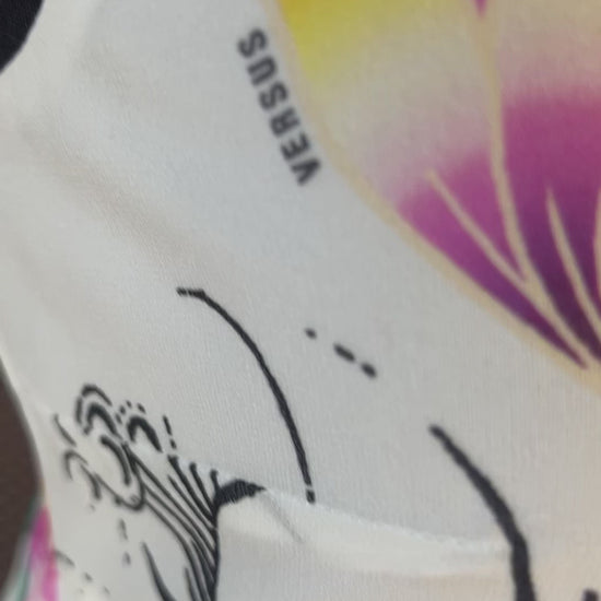 Close-up of Versace Silk Lotus Flower Dress showcasing vibrant flower print and intricate detailing.