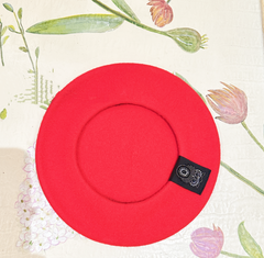 Red 100% wool beret with intricate beading, diameter 28cm, offering warmth and style.