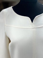 Close-up of Seventy White Dress showcasing elegant A-line design and clean neckline detailing on a dress form.