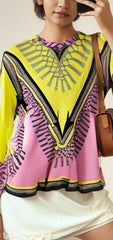 Versace pink and yellow blouse featuring bold design and iconic style, perfect for making a fashion statement.